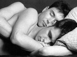 [B&w photo of two young men sleeping in embrace]